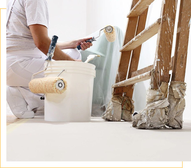 A person painting the floor of a room.